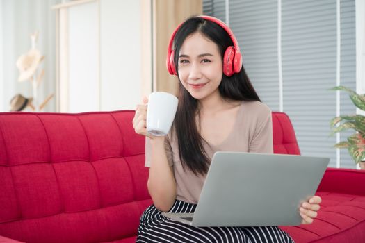 Beautiful woman Asian people are happily using their laptops at home. Working from home is a new normal in the situation where the coronavirus is spreading.