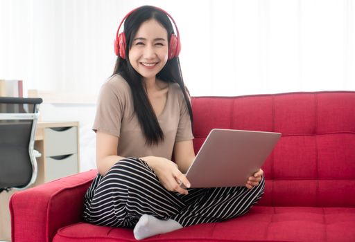 Beautiful woman Asian people are happily using their laptops at home. Working from home is a new normal in the situation where the coronavirus is spreading.