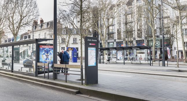 Tours, France - February 8, 2020: travelers in the Jean Jaures electric tram and bus station near the town hall on a winter day