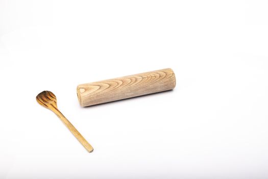 wooden spoon and rolling pin on white background in studio