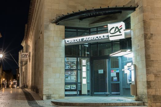 Saint-Emilion, France - May 05, 2017 : facade of a agency of the French merchant bank Credit Agricole in the historic city center on a spring evening