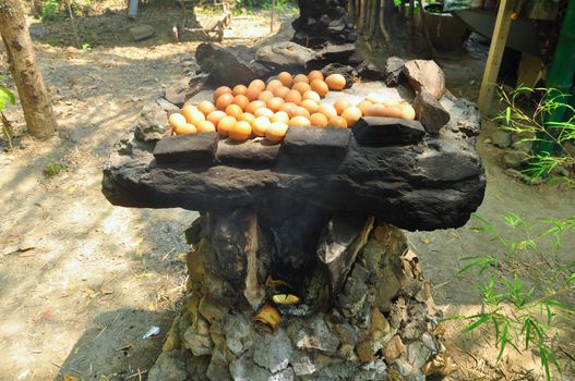 Many eggs are toasted on the stove made of stone pedestals, Folk wisdom of local Thai people.