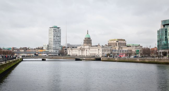 Dublin, Ireland - February 12, 2019: mix of modern and old architecture along the Liffey River in the city center on a winter day