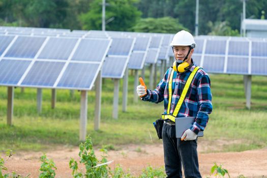 Electricity solar power engineering,Engineer checking solar panel in routine operation at solar power plant.