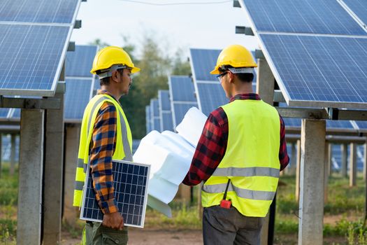 Group of engineer checking solar panel in routine operation at solar power plant,Operation and maintenance in solar power plant,solar power plant to innovation of green energy for life.