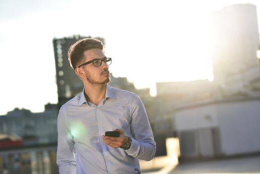 Serious Caucasian businessman dressed at classic wear standing at the street.