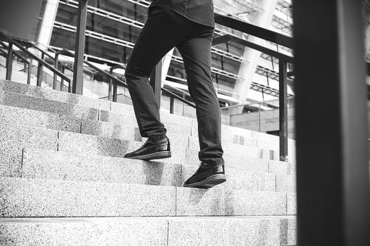 Handsome successful businessman in elegant suit outdoors walking on street in the city.