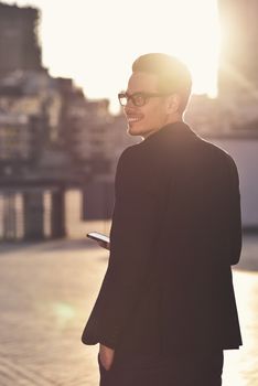 Serious Caucasian businessman dressed at classic wear standing at the street