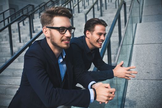 Two awesome businessman have a rest between a work. Speak easy