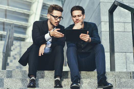 Work time. Two business people discussing strategy on the stair