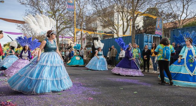 Loule, Portugal - February 25, 2020: dancers parading in the street in front of the public in the parade of the traditional carnival of Loule city on a February day