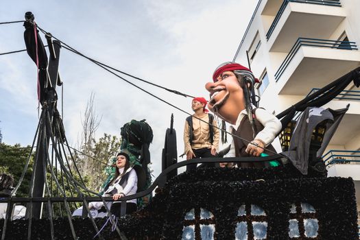 Loule, Portugal - February 25, 2020: Float parading in the street in front of the public in the parade of the traditional carnival of Loule city on a February day