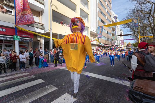 Loule, Portugal - February 25, 2020: Man disguised as a giant in the street in front of the public in the parade of the traditional carnival of Loule city on a February day