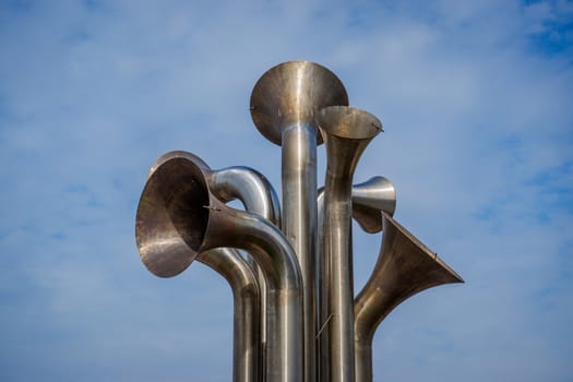 a number of polished steel trumpet shapes made into a sculpture Morecambe