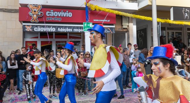 Loule, Portugal - February 25, 2020: dancers parading in the street in front of the public in the parade of the traditional carnival of Loule city on a February day