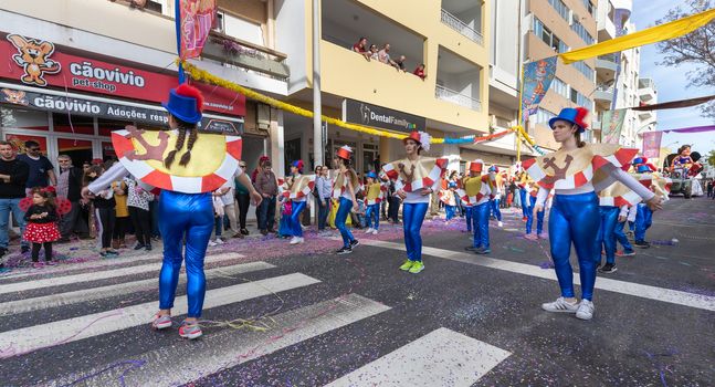 Loule, Portugal - February 25, 2020: dancers parading in the street in front of the public in the parade of the traditional carnival of Loule city on a February day