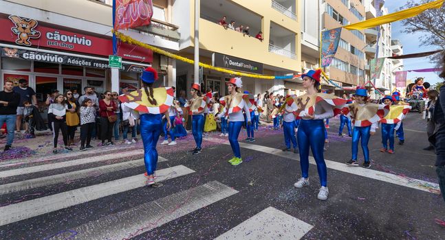 Loule, Portugal - February 25, 2020: dancers parading in the street in front of the public in the parade of the traditional carnival of Loule city on a February day