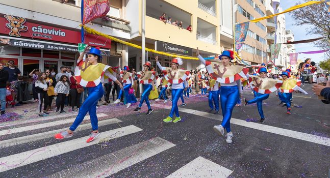 Loule, Portugal - February 25, 2020: dancers parading in the street in front of the public in the parade of the traditional carnival of Loule city on a February day