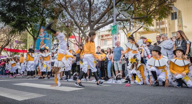 Loule, Portugal - February 25, 2020: dancers parading in the street in front of the public in the parade of the traditional carnival of Loule city on a February day