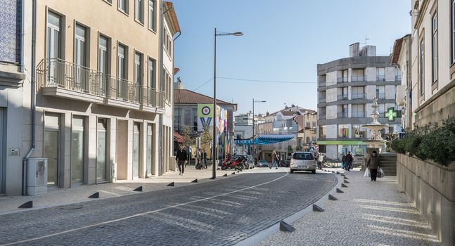 Ovar, Portugal - February 18, 2020: architectural detail of the typical houses of the city decorated for the carnival where people are walking on a winter day