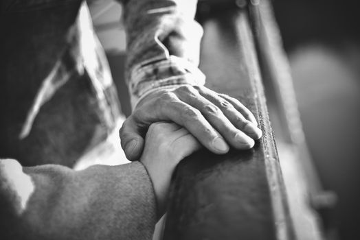 Hand in hand. Man and woman holding by hands in the city