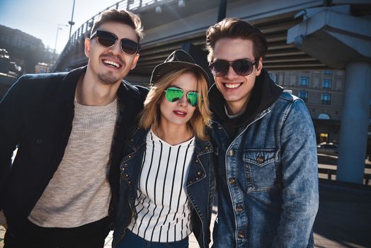 They are so funny. Group of smiling friends having fun enjoying themselves outdoors.