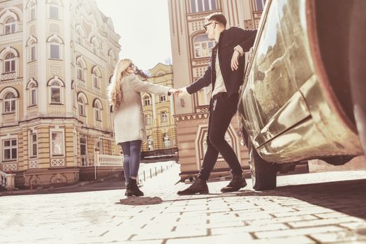 Sunny mood. Lovely couple looking at each other holding hands with smile