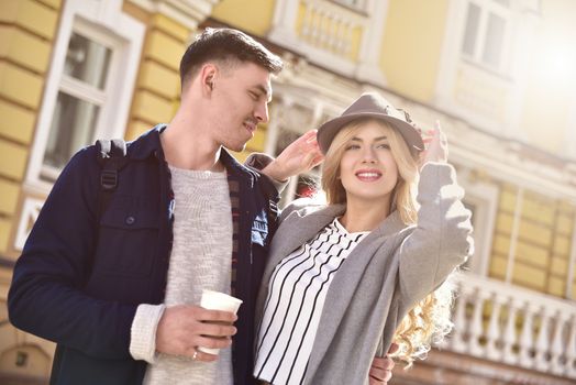 Stylish couple walking at the street having fun