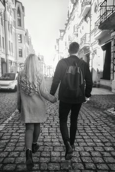 Young couple walk at the street on sunny day