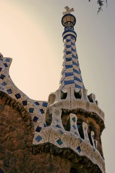 Frame ceramic tile grunge background covered with tile-shard mosaic, Parc Guell designed by Antoni Gaudi located on Carmel Hill, Barcelona, Spain.