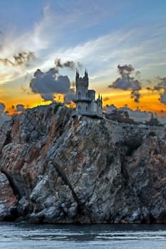 The castle "Swallow's nest". The village of Gaspra on the Crimean background of the cloudy sky, Top of the 40-metre (130 ft) high Aurora Cliff, in a Neo-Gothic design.