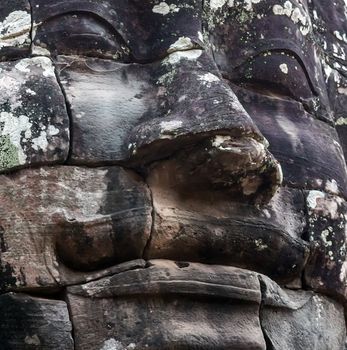 Ancient stone faces of king Bayon Temple Angkor Thom, Cambodia. Ancient monument Khmer architecture Kampuchea.
