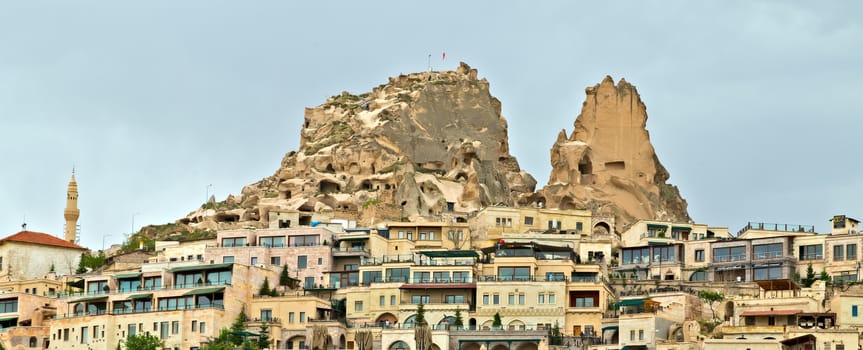 Uchisar castle, Turkey. Rural Cappadocia Mountain landscape panoramic view. Stone houses, Aerial photography.