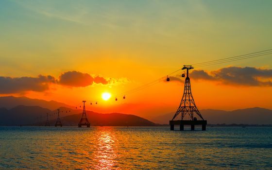 Cable car Colorful Sky At Sunset Dawn Sunrise, cableway long rope road on water bay Nha Trang, Vietnam