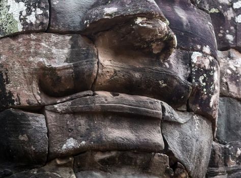 Ancient stone faces of king Bayon Temple Angkor Thom, Cambodia. Ancient monument Khmer architecture Kampuchea.