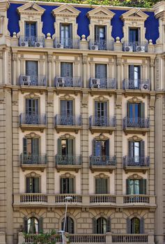 Facade of a building with conditioner balcony and windows in old house