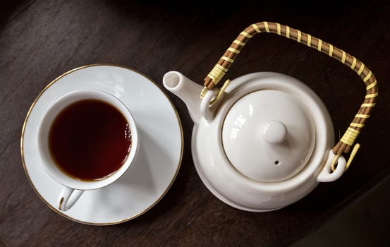 Top view Cup of tea with teapot