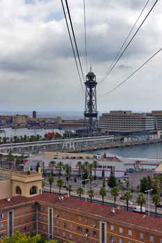 BARCELONA, SPAIN - AUGUST 27, 2012: passenger port of barcelona and tower with a rope-way with an area of sports boats, dock and a shopping area. Catalonia, Spain.