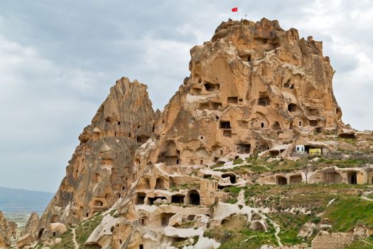 Turkish fortress Uchisar, Turkey. Rural Cappadocia Mountain landscape panoramic view. Stone houses
