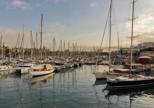 BARCELONA, SPAIN - AUGUST 27, 2012: Port Vell old harbor of Barcelona with an area of sports boats, dock and a shopping area. Catalonia, Spain.