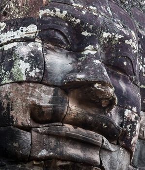 Ancient stone faces of king Bayon Temple Angkor Thom, Cambodia. monument Khmer architecture Kampuchea.