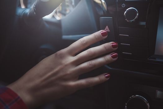 female sit in car and push on red button