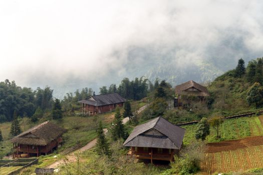 Old rural wooden house cloudy sky, eco tourism mountain Sa Pa. Lao cai province northern Vietnam