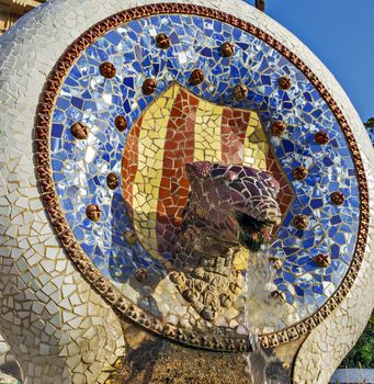 Catalan dragon head Medallion flag Catalonia in Parc Guell, designed by Antonio Gaudi Barcelona, Spain
