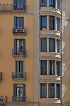 Facade of a building with balcony and windows in old house