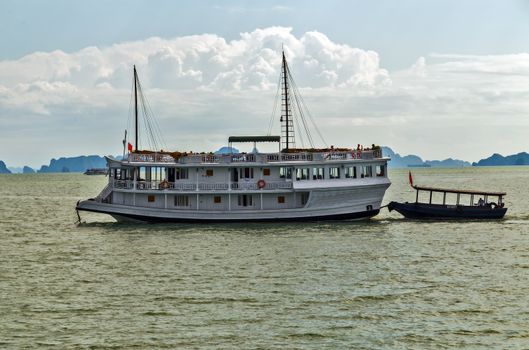Boat cruise Junks and Floating village in Halong Bay, Vietnam.UNESCO World Heritage Site.