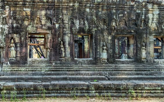 Ruins Window of Angkor Wat, part of Khmer temple complex, Asia. Siem Reap, Cambodia. Ancient Khmer architecture in jungle.