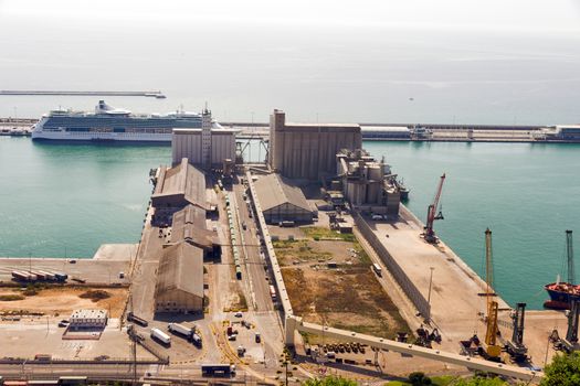 BARCELONA, SPAIN - AUGUST 27, 2012:The cruise ship docked at the port of Barcelona. with an area of sports boats, dock and a shopping area. Catalonia, Spain.