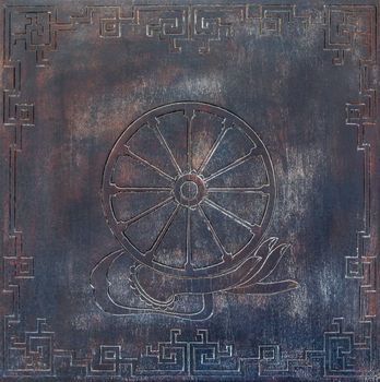 Dharma Wheel Buddhist symbol in old wood