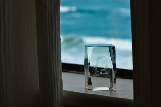 Indoors ocean view windowsill with glass ornament and curtains, Mossel Bay, South Africa